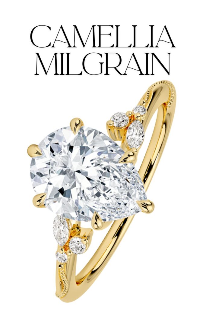 The Camellia Milgrain Pear Shaped Diamond Ring features a stunning pear-cut diamond, showcasing exceptional clarity and brilliance, set in a polished 18K yellow gold band. The band is elegantly designed with delicate floral accents, adorned with smaller round diamonds that enhance its luxurious appeal. This sophisticated ring combines a classic solitaire style with intricate detailing to create a timelessly beautiful piece.