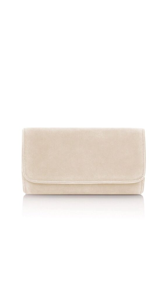 The Emmy London Natasha Clutch is a rectangular, fold-over design crafted from soft blush suede, exuding elegance. Its minimalist silhouette is enhanced by subtle stitching along the edges, making it a versatile accessory for both formal and casual occasions. The gentle blush color adds a touch of femininity while remaining easy to pair with various outfits.