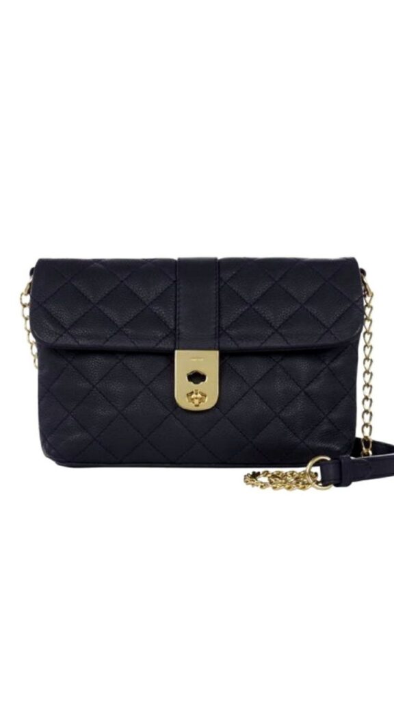 The Jaeger Kate Bag features a structured rectangular silhouette, crafted in navy quilted leather, showcasing a rich texture. It has a gold-tone clasp closure at the front, complemented by a chain and leather shoulder strap for versatile carrying options. The elegant design balances sophistication and practicality, making it suitable for various occasions.
