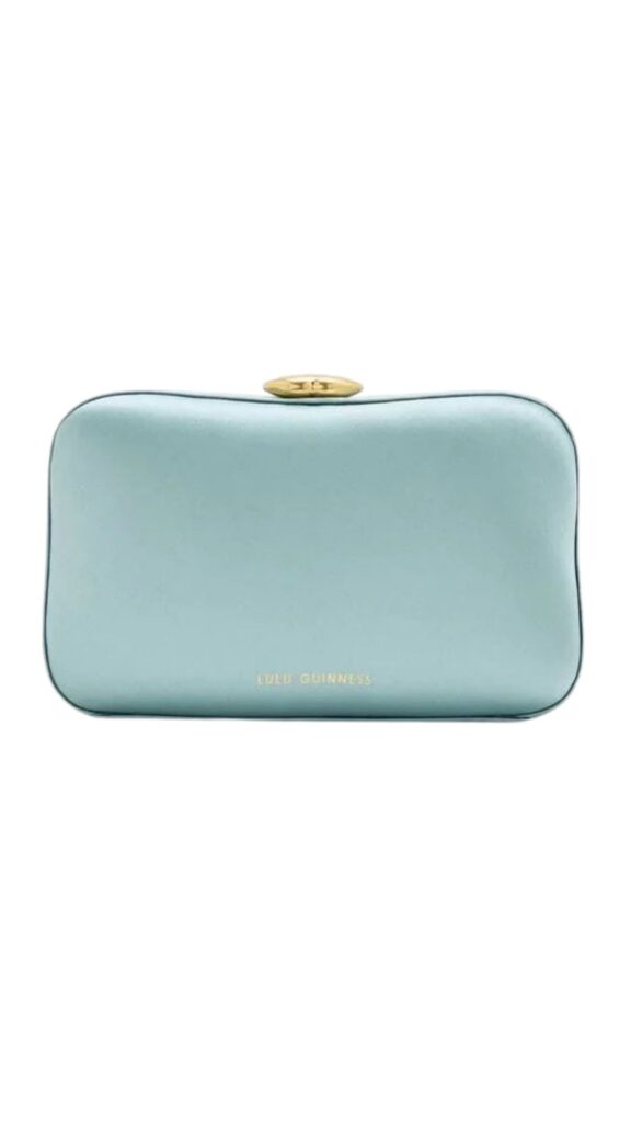 The Lulu Guinness Hayworth Clutch Bag features a sleek, streamlined silhouette that exudes sophistication. Crafted from satin in a soft sea blue hue, it is adorned with a golden clasp closure and includes the brand's name elegantly embossed on the front. This versatile accessory is perfect for formal occasions, adding a touch of elegance to any outfit.