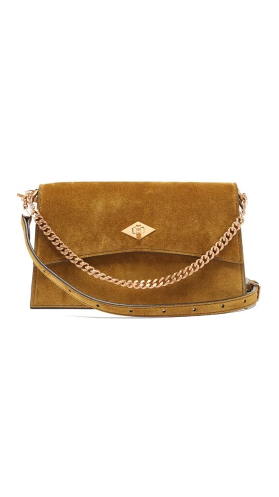 This Metier Roma Small Brown Suede Shoulder Bag features a sleek rectangular silhouette, with a hinged flap closure and a prominent diamond-shaped emblem. The warm brown suede exterior is complemented by an elegant gold-tone chain strap, adding a touch of sophistication. The bag combines both functionality and style, making it perfect for various occasions.