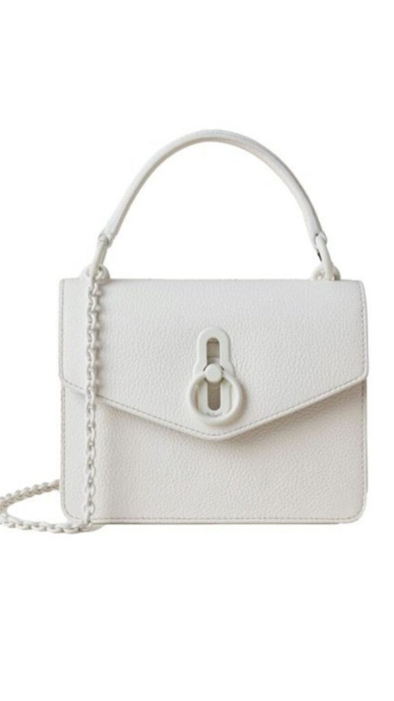 The Mulberry Amberley Small Crossbody Bag features a sleek rectangular silhouette with a structured design. It is crafted in a soft white leather, complemented by a distinct round metal fastening and a detachable chain strap for versatility. The bag presents an elegant aesthetic suitable for various occasions.