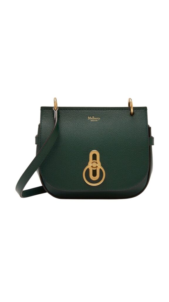 The Mulberry Small Amberley Satchel Shoulder Bag is a structured, rectangular design in rich green leather, complemented by a distinctive gold-toned circular lock closure. It features a long, adjustable shoulder strap for versatile wear, making it both stylish and functional. The bag's elegant silhouette and premium materials offer a sophisticated touch to any outfit.