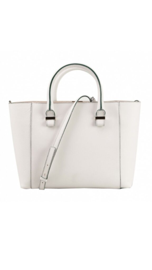 The Victoria Beckham Quincy Bag features a structured silhouette with dual top handles and a detachable shoulder strap for versatile carrying options. It is crafted in a soft white leather, accented by subtle stitching detail and minimal hardware for a sleek, modern look. This handbag’s aesthetic blends elegance and practicality, making it suitable for various occasions.
