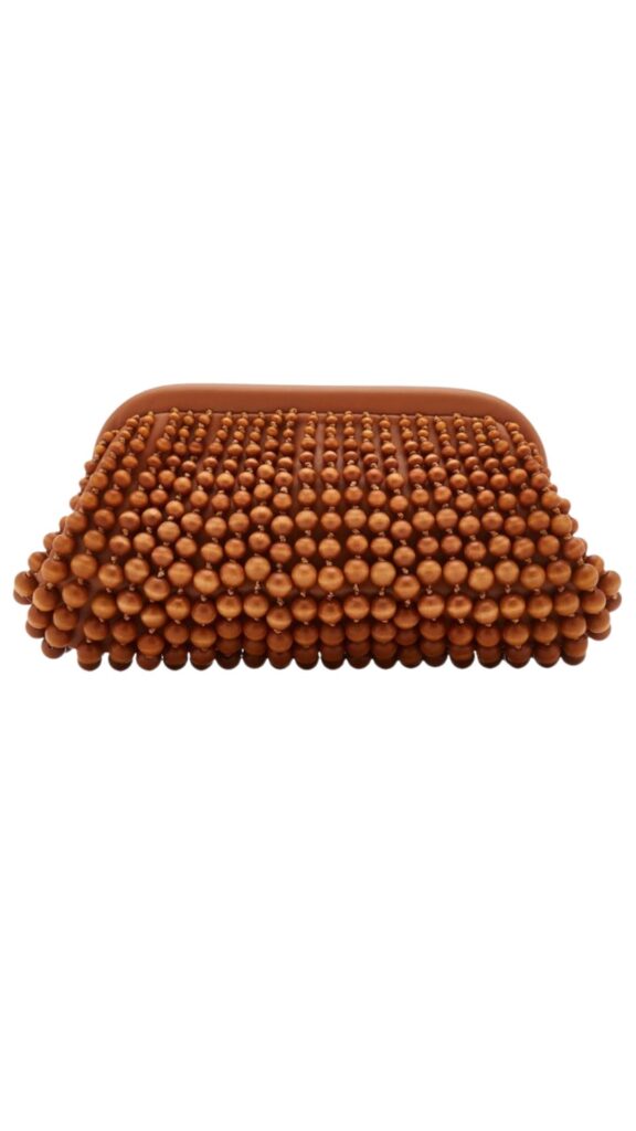 The Cult Gaia Nia Beaded Leather Clutch features a rectangular silhouette adorned with an intricate array of round, beaded textures, creating a striking tactile design. It showcases a warm, earthy brown color that adds versatility and elegance. The clutch is crafted from supple leather, making it a chic accessory suitable for various occasions.